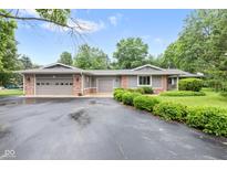 Charming single-story home featuring a multi-car garage, brick accents, and well-maintained landscaping at 6575 E 171St St, Noblesville, IN 46062