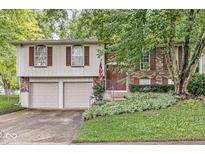 Charming two-story home featuring brick and siding, complemented by a well-manicured lawn and inviting curb appeal at 7616 E Concord Ln, Fishers, IN 46038