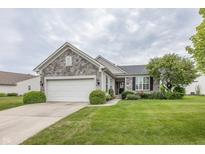 Charming single-story home with stone accents, well-maintained lawn, and attached two-car garage at 12880 Oxbridge Pl, Fishers, IN 46037