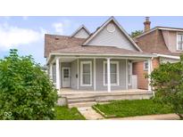 Charming, two-story home with welcoming front porch and well-maintained landscaping at 1310 California St, Columbus, IN 47201