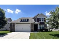 Charming two-story home with a brick and siding exterior, attached two-car garage, and well-manicured lawn at 13992 Wynngate Ln, Fishers, IN 46038