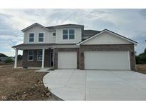 Beautiful two-story home featuring a two-car garage and a brick and siding facade at 171 Ames Dr, Whiteland, IN 46184