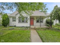 Charming home featuring a well-manicured lawn, inviting walkway, and a cozy front porch with red door at 1739 Caldwell Pl, Columbus, IN 47201