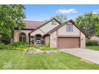 Charming two-story brick home with a well-manicured lawn and an attached two-car garage at 259 Glenbrook Ln, Avon, IN 46123