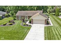 Lovely single-story home with a brick facade, attached garage, and well-manicured front yard at 272 N Peterman Rd, Greenwood, IN 46142