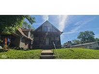 Charming two-story home with a covered porch and steps leading to the entrance at 435 N Rural Ne St, Indianapolis, IN 46201