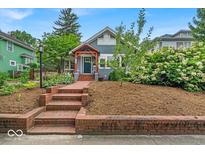 Charming two-story home featuring well-maintained landscaping and an inviting brick entryway at 4356 N College Ave, Indianapolis, IN 46205