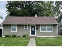 Charming single-story home featuring a well-maintained lawn, inviting entryway and a classic, neutral color scheme at 4761 Payton Ave, Lawrence, IN 46226
