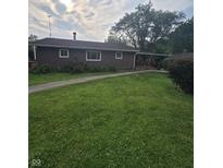 Quaint single story home featuring a well manicured lawn and inviting front porch at 509 S E St, Arcadia, IN 46030