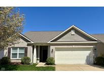 Charming single-story home featuring a two-car garage and well-maintained landscaping under a bright blue sky at 5932 Edelle Dr, Indianapolis, IN 46237