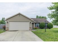 Charming single-story home with a two-car garage, well-maintained lawn, and inviting curb appeal at 63 Longfellow Ln, Greenfield, IN 46140