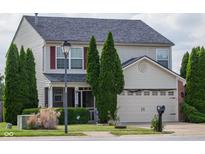 Charming two-story home with well-maintained landscaping, a two-car garage and traditional curb appeal at 6524 Amick Way, Indianapolis, IN 46268