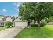 Charming single-Gathering home with a well-manicured lawn and a two-car garage at 6937 Thousand Oaks Dr, Indianapolis, IN 46214