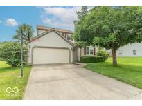 Two-story home with a two-car garage, basketball hoop, and well-maintained landscaping at 6937 Thousand Oaks Dr, Indianapolis, IN 46214