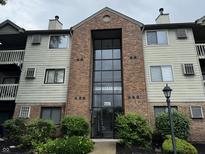 Attractive multi-story condo building with brick facade, large windows, and well-maintained landscaping at 7220 Village Pkwy Dr # 3, Indianapolis, IN 46254
