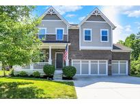 Two-story home with brick and siding, front porch, and three-car garage in a residential neighborhood at 773 Bracknell Dr, Avon, IN 46123