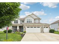 Charming two-story home featuring a stone facade, three-car garage, and manicured lawn in a well-kept neighborhood at 8126 Kilborn Way, Avon, IN 46123