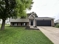 Charming two-story home with a well-manicured lawn and a two car garage at 8277 N Waterford Dr, Columbus, IN 47201