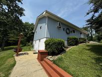 Charming two-story home with light blue siding, green lawn, and inviting walkway at 8664 S Nash Dr, Nineveh, IN 46164
