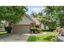 Charming single Gathering home with mature landscaping and a two car attached garage at 1067 Acadia Ct, Indianapolis, IN 46217