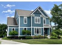 Charming two-story home with blue siding, white trim, and a well-manicured lawn at 13895 Cloverfield Cir, Fishers, IN 46038