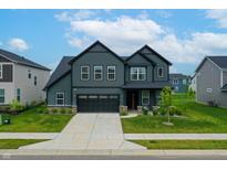 Beautiful two-story home featuring dark siding, a well-maintained lawn, and an attached two-car garage at 15192 Montfort Dr, Noblesville, IN 46062