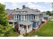 Impressive two-story home featuring a classic design, landscaped yard, and inviting front porch at 1531 N College Ave, Indianapolis, IN 46202