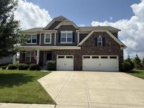 Charming two-story home with brick accents, a well-manicured lawn, and a spacious three-car garage at 15961 Foothill Dr, Noblesville, IN 46060