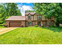 Charming two-story home with a well-manicured lawn and a classic Tudor-style facade at 1660 Obara Ct, Carmel, IN 46033