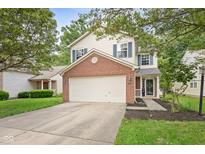 Charming two-story home with a brick accent and a two-car garage, nestled among mature trees at 2289 Salem Park Dr, Indianapolis, IN 46239