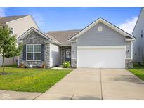 Charming single-story home featuring stone accents, gray siding, and a well-manicured front yard at 2421 Creek Bank Dr, Columbus, IN 47201