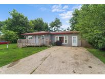 Charming one-story home with a long drive and a cozy front deck at 2610 Caroline Ave, Indianapolis, IN 46218