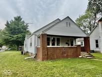 Cozy home with brick accents and a welcoming front porch on a well maintained lawn at 313 S Brittain Ave, Muncie, IN 47303