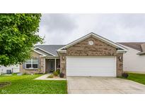 Charming brick home featuring a two-car garage and a well-maintained lawn with beautiful landscaping at 3872 Dusty Sands Rd, Whitestown, IN 46075
