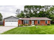 Charming single-story brick home with a well-manicured lawn, tidy landscaping, and an attached two-car garage at 4191 N Graham Rd, Whiteland, IN 46184