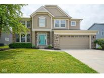 Charming two-story home featuring a manicured lawn, a two-car garage, and a welcoming turquoise-colored front door at 6471 W Clearview Dr, McCordsville, IN 46055