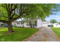 Charming single-story home with a well-maintained front yard and detached garage at 717 Berkeley Dr, Shelbyville, IN 46176
