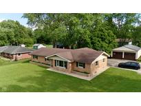 Charming brick home with a well-maintained lawn and detached garage at 771 Doran Ave, Shelbyville, IN 46176