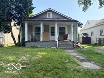 Charming home featuring a welcoming front porch and a classic architectural design at 822 W 7Th St, Muncie, IN 47302