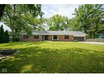 Well-maintained brick home with lush green lawn and mature trees offering great curb appeal at 1015 Fox Hill Dr, Indianapolis, IN 46228