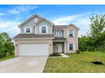 Charming two-story home with brick and siding, attached two-car garage and well-maintained lawn at 1571 N Creekwater Pass, Greenfield, IN 46140