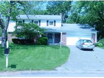Charming two-story home with a well-manicured lawn and an attached garage at 1808 Orchid Ct, Indianapolis, IN 46219