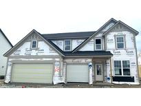 New two-story home showcasing a modern elevation with attached two-car garage, still under construction phase at 19976 Stone Side Dr, Westfield, IN 46074