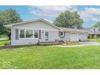 Charming single-story home with gray brick, a two-car garage, and well-maintained landscaping at 2875 E Woodside Dr, Mooresville, IN 46158