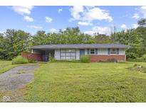 Charming single-story home with a brick base, light blue siding, and a spacious front yard at 31 Brooklyn Ct, Mooresville, IN 46158