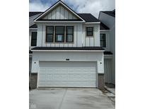 Modern two-story home features a white garage door, complementary trim, and black-framed windows at 3307 Noriker Ln, Zionsville, IN 46077