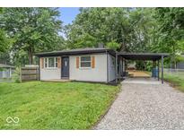Charming one-story home with gray brick, wood shutters, and a convenient carport at 360 Richie Ave, Indianapolis, IN 46234