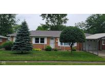 Charming single-story brick home featuring a well-maintained lawn and mature trees at 420 Brookside Ln, Plainfield, IN 46168