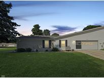 Charming single-story home featuring an attached garage and a well-maintained front lawn with mature trees at 4329 Rutgers Dr # 40B, Anderson, IN 46013