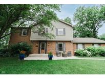 Charming two-story home with brick and siding facade, complemented by a well-manicured lawn at 46 Hawthorne Ct, Carmel, IN 46033
